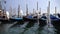 Gondolas by embankment against San Giorgio Maggiore island