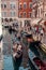 gondolas gracefully glide through narrow canals, weaving past vibrant, colorful houses, creating a captivating scene in the