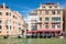 Gondolas and luxury hotel on an old palace by the Grand Canal in Venice