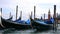 Gondolas moored at dock in Venice Italy.