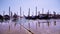 Gondolas moored to pier near bay in Venice on sunny day