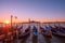 Gondolas moored to the poles in Europe Venice near the city center and Saint Mark square