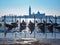 Gondolas moored in Venice and the Cathedral of San Giorgio Maggiore