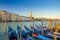 Gondolas moored in water of Grand Canal waterway in Venice