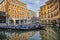 Gondolas park in the canal near San Marco with mirroring reflection of shop Zara and hotel Cavalletto