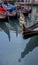 Gondolas parked on a canal in Venice, Italy showing the decorative ferro / iron at the bow of the boats and the risso