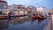 Gondolas parked in the Central Canal in the early evening, row of Art Nouveau townhouses in the background, Aveiro, Portugal