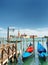 Gondolas parked at pier beside the Riva degli Schiavoni, Venice