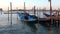 Gondolas at the pier in San Marco bay, morning of september. Venice, Italy