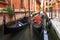 Gondolas in Venezia along old houses in narrow canal. Venice cityscape. Venetian street landscape