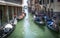 Gondolier on the boat approaching the mooring gondolas. Venice.