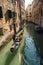 Gondolier on canal in Venice