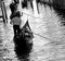 Gondolier in the canal in Venice in Italy