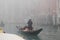 Gondolier carries tourists through the canals of Venice.