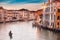 Gondolier carries tourists on gondola Grand Canal of Venice, Italy