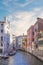 A gondolier drives a gondola with tourists in Venice