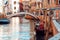 Gondolier floats on the narrow channel in Venice, Italy