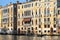 Gondolier floats past the old palazzo in Venice