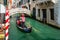 Gondolier on a gondola on canal street in Venice, Italy