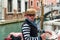Gondolier on a gondola on canal street in Venice, Italy