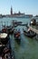 Gondolier and his gondola awaiting tourists for a ride at Grand canal in Venice