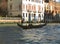 Gondolier Sailing a Gondola against Venetian Style Building On Grand Canal, Venice