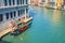 Gondolier on sailing gondola traditional boat in water of Grand Canal waterway in Venice