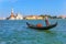 A gondolier sailing to San Giorgio Maggiore island in Venetian lagoon