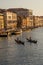 Gondolier taking tourists on a Gondola ride along the grand canal near Rialto Hotel in Venice, Italy