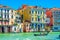 Gondolier and tourists on gondola traditional boat sailing on water of Grand Canal in Venice