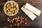 Goober in bowl, peeled groundnut and nougat with peanut on table. Top view