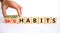 Good or bad habits symbol. Businessman turns wooden cubes and changes words `bad habits` to `good habits`. Beautiful white tab