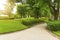 Good care maintenance garden of gray curve pattern walkway, sand washed finishing on concrete paving, brown gravel border, smooth