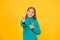 Good choice. Happy girl pointing gun hand gesture. Target and targeting. Small child smiling and pointing yellow