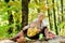 Good day for spring picnic in nature. Having snack during hike. Happy childhood. Mom and kid boy relaxing while hiking