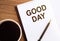 GOOD DAY - text on notepad on wooden desk