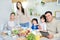 Good food makes your day. Hispanic family smiling at camera while enjoying a meal together at home. Middle aged father