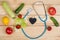 Good healthy and diet concept - Blackboard in shape of heart, stethoscope and vegetables, fruits and berries