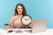 Good job, time to work! Positive happy woman, satisfied office employee sitting at workplace, holding big clock