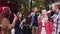 Good-looking cheerful young mates giving high five with bottles of non-alcoholic drinks and resting in the gazebo with