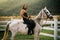 Good looking, hunky cowboy rides horse at beautiful country side nature. Equestrian rides his white well looking horse