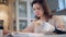 Good-looking lady with a bionic hand is reading and eating a cookie