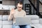 Good-looking man sitting at the laptop and waving the hand