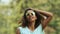 Good-looking multiracial female enjoying music at festival, making dance moves