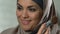 Good-looking muslim woman applying face powder, doing make-up, luxury cosmetics