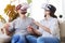 Good-looking pair in VR goggles holding hands and orienting in s