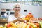 Good-looking senior woman wearing glasses buys pepper on market
