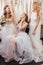 Good-looking three women together in wedding dresses