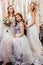 Good-looking three women together in wedding dresses