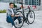 Good-looking young man fixing a problem with a bike tire